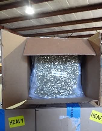 A cardboard box packed with bundles of cannabis wrapped in plastic, part of the seized shipment.